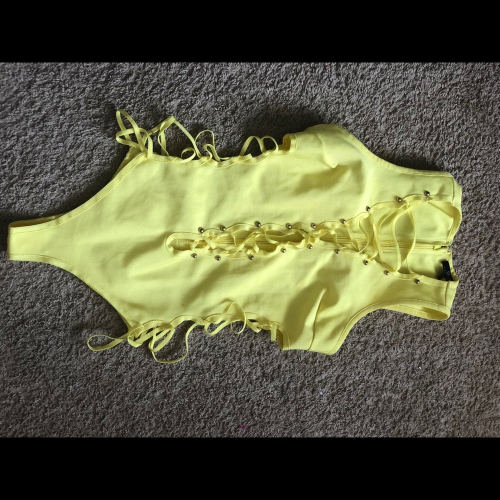 NWOT never worn pristine gorgeous yellow Bodysuit criss cross  front opening